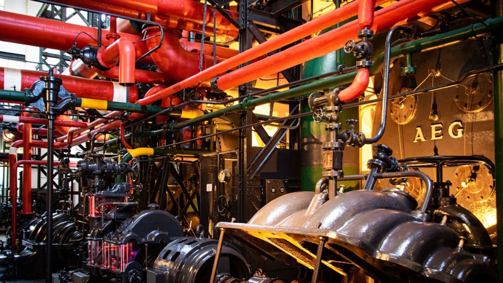 Выкуп генераторов в Санкт-Петербурге — Vibrant industrial machinery with red pipes and complex equipment in a factory.