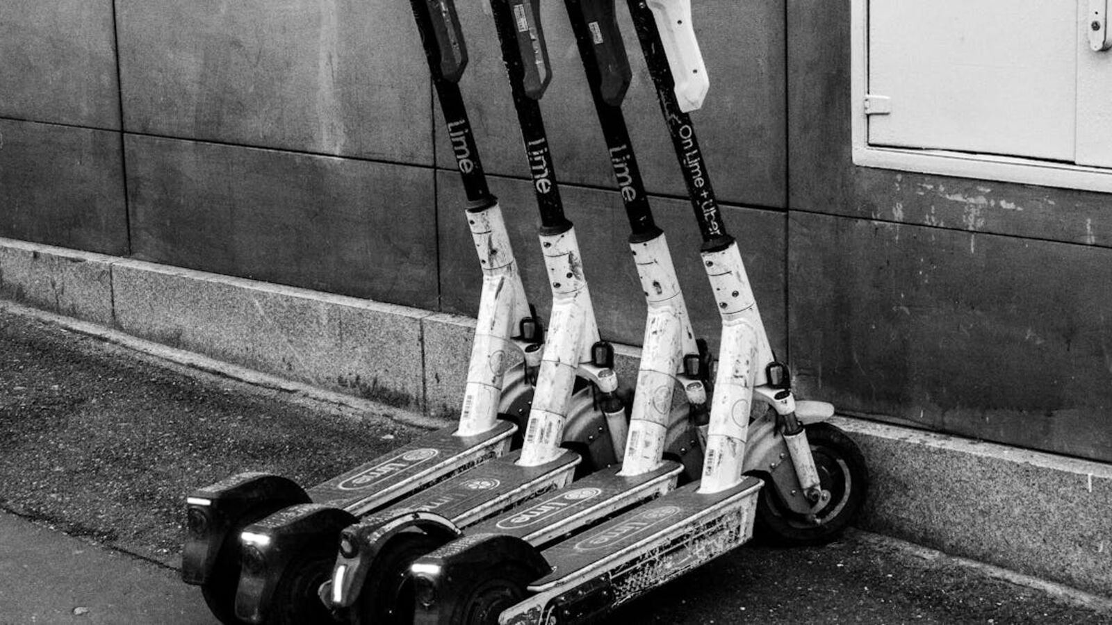 Кейс: продажа скутера в быстром сценарии в Санкт-Петербурге — A group of electric scooters parked against a building wall, highlighting urban transportation.