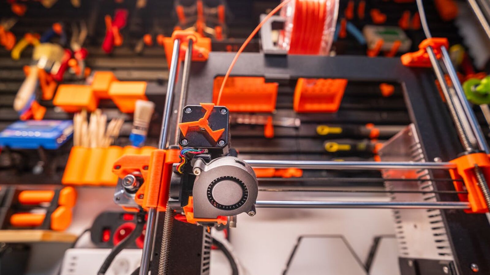 Кейс: продажа сложного нестандартного объекта бизнеса в Санкт-Петербурге — Detailed view of a 3D printer with filament and tools in a workshop setting.