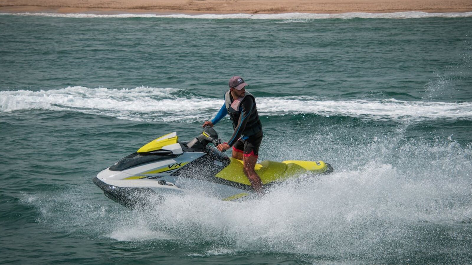 Выкуп гидроциклов в Санкт-Петербурге — Male enjoying a thrilling ride on a jet ski across ocean waves, showcasing adventure and fun.