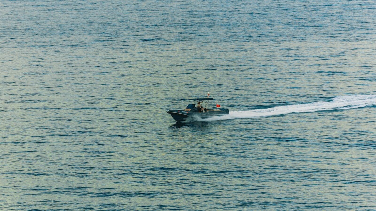 Выкуп стационарных лодочных моторов в Санкт-Петербурге — A fast speedboat cuts through the serene waters, showcasing a sense of adventure and freedom.
