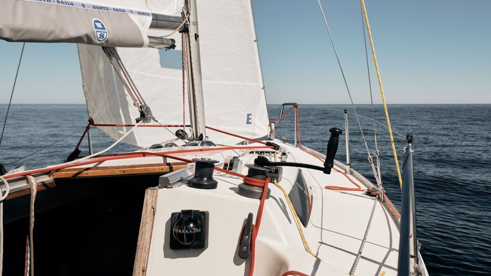 Кейс: продажа парусной яхты вне сезона в Санкт-Петербурге — A sailboat navigating through the open sea under clear skies.